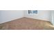 Empty carpeted bedroom with neutral walls and window at 4767 Cragmere Loop, Clermont, FL 34711