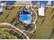 Aerial view of community pool with lounge chairs and landscaping at 4767 Cragmere Loop, Clermont, FL 34711