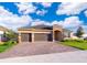 New 3-car garage home with paver driveway and landscaped lawn at 4767 Cragmere Loop, Clermont, FL 34711