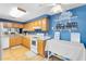 Kitchen with light wood cabinets, blue walls, and a pantry at 513 Goodridge Ln, Fern Park, FL 32730