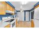 Kitchen with light wood cabinets and blue walls at 513 Goodridge Ln, Fern Park, FL 32730