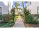 Inviting community walkway with lush landscaping and arched entryway at 5159 Wellington Park Cir # 36, Orlando, FL 32839