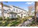 Two-story townhome with gray exterior, landscaping, and walkway at 5159 Wellington Park Cir # 36, Orlando, FL 32839