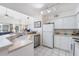 White kitchen with stainless steel appliances and light counters at 5159 Wellington Park Cir # 36, Orlando, FL 32839