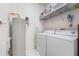 Convenient laundry room with washer, dryer, and additional shelving at 5159 Wellington Park Cir # 36, Orlando, FL 32839