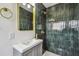 Bathroom with dark green tile shower and gold accents at 5216 Bonnie Brae Cir, Orlando, FL 32808