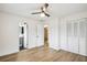 Bright bedroom with light wood floors, ceiling fan and en-suite bathroom at 5216 Bonnie Brae Cir, Orlando, FL 32808