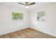 Well-lit bedroom with two windows and wood-look flooring at 5216 Bonnie Brae Cir, Orlando, FL 32808