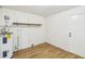 Laundry room with wood shelving, water heater, and light wood flooring at 5216 Bonnie Brae Cir, Orlando, FL 32808