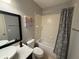 Clean bathroom with tub shower, updated vanity, and tasteful decor at 5550 E Michigan St # 2223, Orlando, FL 32822