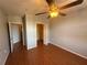 Spacious bedroom with wood floors, ceiling fan, and walk-in closet at 5550 E Michigan St # 2223, Orlando, FL 32822