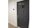 Modern dark gray condo entry door with wreath at 5550 E Michigan St # 2223, Orlando, FL 32822