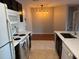 Modern kitchen with island, breakfast bar, and updated flooring at 5550 E Michigan St # 2223, Orlando, FL 32822