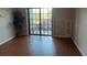 Living room with wood floors, sliding doors to balcony at 5550 E Michigan St # 2223, Orlando, FL 32822