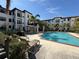 Inviting community pool with lounge chairs and pergola at 5550 E Michigan St # 2223, Orlando, FL 32822