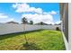 Large backyard with green grass, a privacy fence, and young trees at 558 Pawnee Ct, Haines City, FL 33844