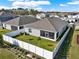 Aerial view of a well-maintained backyard with a white fence and manicured landscaping at 558 Pawnee Ct, Haines City, FL 33844