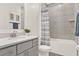 Well-lit bathroom features a single vanity, a toilet, and a bathtub with shower at 558 Pawnee Ct, Haines City, FL 33844