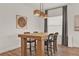 Dining area with modern table, stylish chairs, and elegant lighting fixture at 558 Pawnee Ct, Haines City, FL 33844