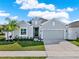 Charming single-story home with a well-manicured lawn and lush landscaping at 558 Pawnee Ct, Haines City, FL 33844