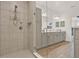 Bright and airy main bathroom featuring a dual vanity, glass shower, and modern finishes at 558 Pawnee Ct, Haines City, FL 33844