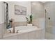 Clean and modern bathroom featuring a tub, shower, and decorative elements at 558 Pawnee Ct, Haines City, FL 33844