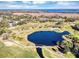 Aerial view of golf course community with lake and resort at 706 Santa Cruz Ln, Howey In The Hills, FL 34737