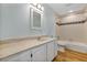 Bathroom with white vanity, beige tile, and a tub at 706 Santa Cruz Ln, Howey In The Hills, FL 34737