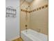 Clean bathroom with beige tile and a shower/tub combination at 706 Santa Cruz Ln, Howey In The Hills, FL 34737