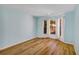 Light blue bedroom with wood-look floors and large window at 706 Santa Cruz Ln # 706, Howey In The Hills, FL 34737