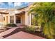 Front entrance with terracotta tile walkway and palm trees at 706 Santa Cruz Ln, Howey In The Hills, FL 34737