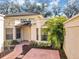 Inviting front entry with tiled walkway and landscaping at 706 Santa Cruz Ln, Howey In The Hills, FL 34737