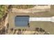 Aerial view of a grey home featuring the roof, driveway, and landscaping at 7542 Sw 128 Terrace Rd, Dunnellon, FL 34432