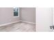 Bright bedroom features wood-look floors and a sunny window at 7542 Sw 128 Terrace Rd, Dunnellon, FL 34432