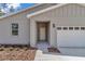 Close-up view of the front entrance featuring tidy landscaping at 7542 Sw 128 Terrace Rd, Dunnellon, FL 34432