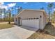Gray exterior of a one-story house featuring a two-car garage and landscaped yard at 7542 Sw 128 Terrace Rd, Dunnellon, FL 34432