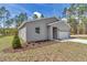 The gray exterior, and well-manicured lawn enhance the home's curb appeal at 7542 Sw 128 Terrace Rd, Dunnellon, FL 34432