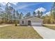 Attractive single-Gathering home with a clean white garage door and gray exterior at 7542 Sw 128 Terrace Rd, Dunnellon, FL 34432