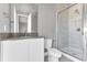 Modern bathroom with a walk-in shower, white toilet, and dark vanity at 7770 Sandy Ridge Dr # 240, Kissimmee, FL 34747