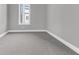 Empty bedroom with grey walls, carpet flooring, and a window at 7770 Sandy Ridge Dr # 240, Kissimmee, FL 34747