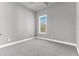 Small bedroom with grey walls, carpet flooring, and a window at 7770 Sandy Ridge Dr # 240, Kissimmee, FL 34747