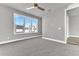 Bright bedroom with gray walls, carpet flooring, and a large window at 7770 Sandy Ridge Dr # 240, Kissimmee, FL 34747