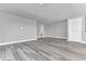 Simple living room with grey walls, wood-look flooring, and an open floor plan at 7770 Sandy Ridge Dr # 240, Kissimmee, FL 34747