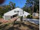 Unique gray two-story home with creative vertical column design and inviting driveway and landscaping at 800 Lake Marion Dr, Altamonte Springs, FL 32701