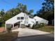 Modern gray two-story home with unique architecture, inviting driveway and beautiful green landscaping at 800 Lake Marion Dr, Altamonte Springs, FL 32701