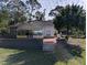 Back exterior view of house with patio, landscaping, and screened porch at 800 Lake Marion Dr, Altamonte Springs, FL 32701