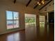 Living room with hardwood floors, large windows, and access to a sunroom at 800 Lake Marion Dr, Altamonte Springs, FL 32701