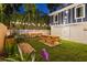 Landscaped backyard with picnic table, string lights, and wooden fence at 806 Palmer St, Orlando, FL 32801