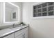 Modern bathroom with updated vanity and a glass block window at 806 Palmer St, Orlando, FL 32801