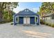 Charming blue house with a paved courtyard and landscaping at 806 Palmer St, Orlando, FL 32801